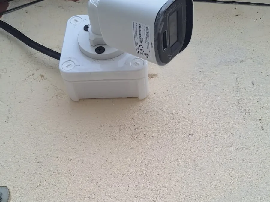 Wall-mounted CCTV camera and its junction box on a building exterior