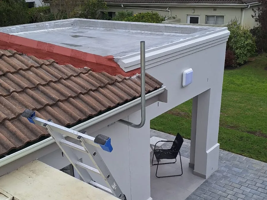 Satellite dish mounted on a roof with its bracket and cabling