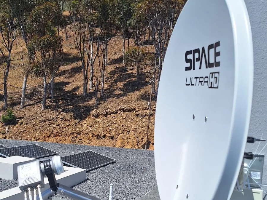 Satellite dish for a non-DStv platform mounted on a house exterior