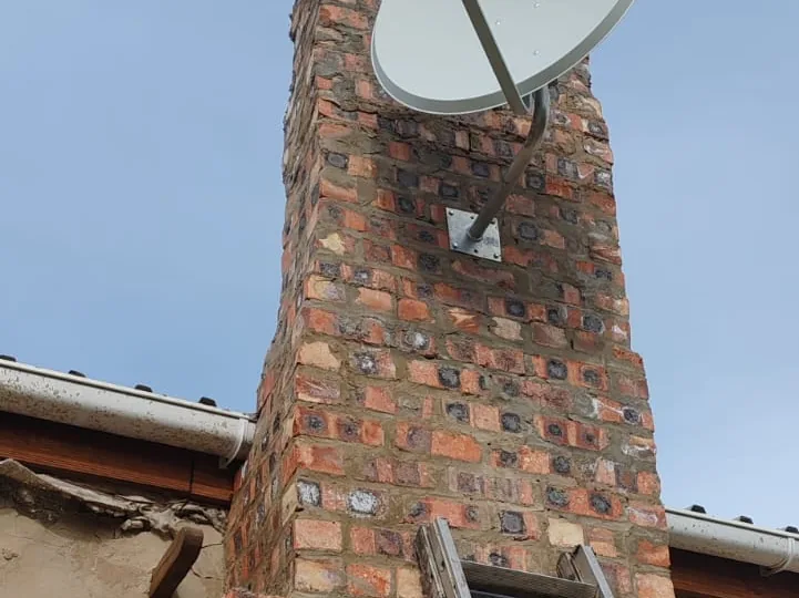 Technician working at height on a satellite dish installation