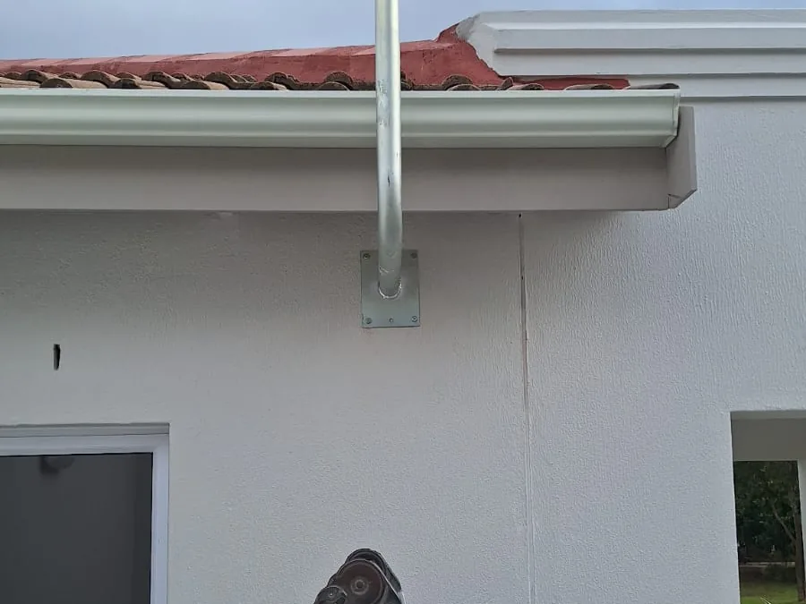 Technician working at height on a satellite dish installation